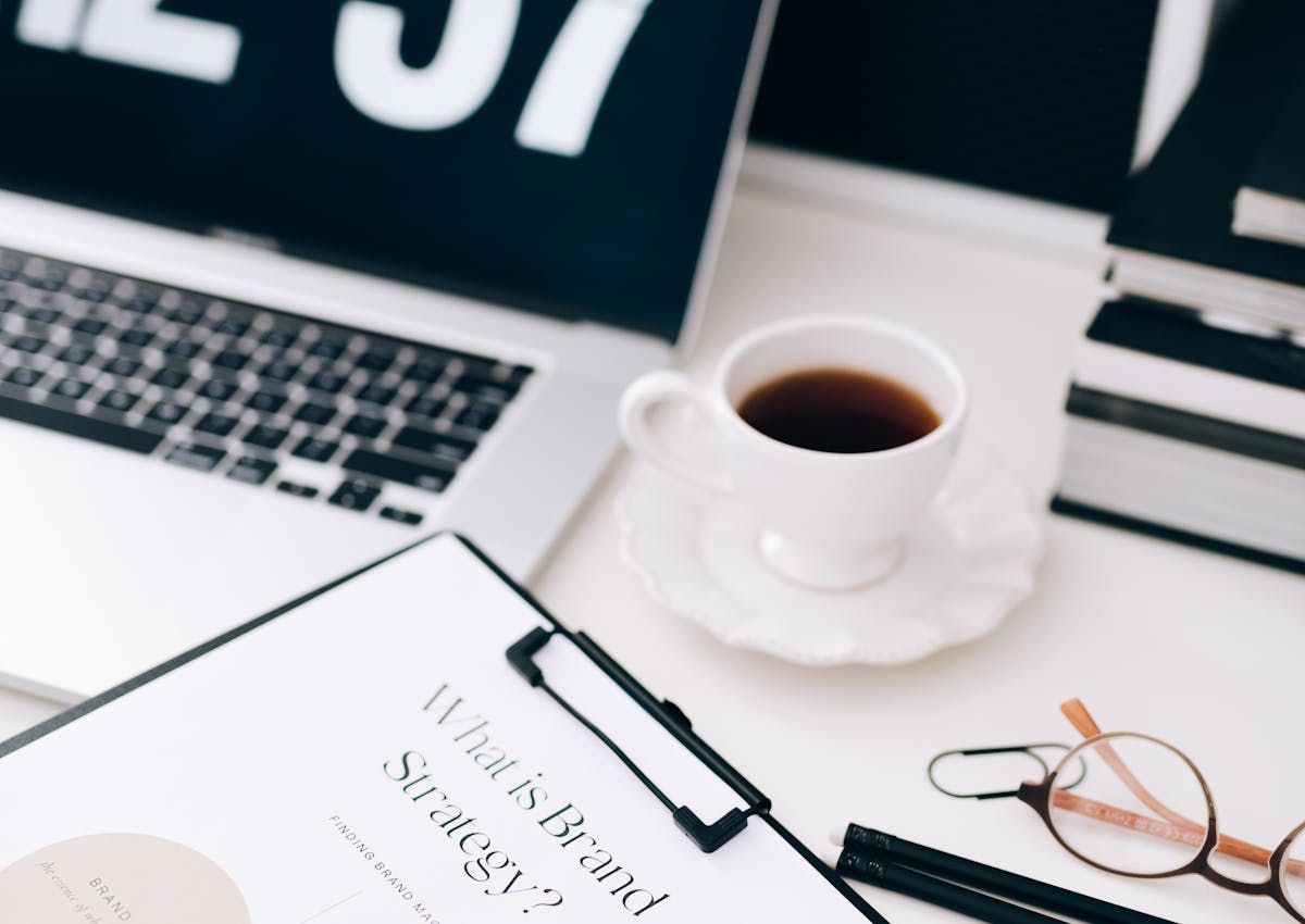 A strategy desk with brand planning notes, laptop, and business materials