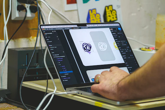 Laptop screen showing branding and business identity design work