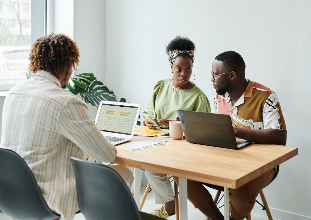 Business owners and an advisor reviewing brand and growth plans together